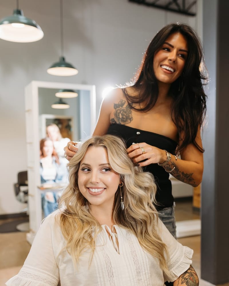 A stylist and her smiling client